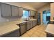 Contemporary kitchen featuring gray cabinets, stainless steel appliances, and a tile backsplash at 21 Pecan Course Cir, Ocala, FL 34472