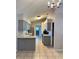 Bright kitchen with gray cabinets, tile floors, ample counter space, and modern appliances at 21 Pecan Course Cir, Ocala, FL 34472
