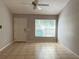 A bright living room with a large window, neutral walls, and tile flooring at 21 Pecan Course Cir, Ocala, FL 34472