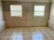 Bright, spacious room featuring tile floors and natural light from two windows at 21 Pecan Course Cir, Ocala, FL 34472