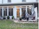 Back patio with lush plants, outdoor seating, and well-manicured lawn at 231 Ne 28Th Ave # 207, Ocala, FL 34470