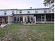 Expansive backyard featuring mature trees, lush greenery, back patio and screened porches at 231 Ne 28Th Ave # 207, Ocala, FL 34470