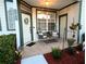 Close-up of a welcoming front porch with seating, plants, and a decorative wreath on the door at 231 Ne 28Th Ave # 207, Ocala, FL 34470