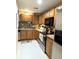 Functional kitchen with stainless steel appliances, ample cabinet space, and tile flooring at 231 Ne 28Th Ave # 207, Ocala, FL 34470