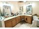 Main bathroom featuring dual sinks, tile floors, and bright lighting at 231 Ne 28Th Ave # 207, Ocala, FL 34470