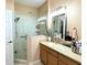 Bathroom boasting a glass-enclosed shower, stylish vanity, and bright lighting at 231 Ne 28Th Ave # 207, Ocala, FL 34470
