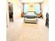 Spacious main bedroom with tray ceiling, carpet, and large windows for natural light at 231 Ne 28Th Ave # 207, Ocala, FL 34470