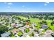Gorgeous aerial view of a community with lush landscaping and a stunning golf course in the distance at 3141 Roswell Rd, The Villages, FL 32162