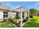Backyard with a pergola, dining table, lush lawn, and attractive landscaping at 3141 Roswell Rd, The Villages, FL 32162