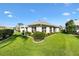 Well-manicured backyard with lush green lawn and neatly trimmed bushes and shrubs at 3141 Roswell Rd, The Villages, FL 32162