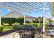 Landscaped backyard featuring patio under a pergola, lush lawn, and well-maintained greenery at 3141 Roswell Rd, The Villages, FL 32162