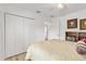 Bright bedroom with white closet doors, ceiling fan, and a comfortable-looking bed at 3141 Roswell Rd, The Villages, FL 32162