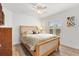 Comfortable bedroom with a wooden bed frame, plantation shutters, and a calming ambiance, designed for restful sleep at 3141 Roswell Rd, The Villages, FL 32162