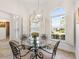 Cozy dining area with a glass table, four chairs, and lots of natural light at 3141 Roswell Rd, The Villages, FL 32162