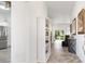 Bright hallway featuring a built-in bookcase and views of the living room and kitchen at 3141 Roswell Rd, The Villages, FL 32162