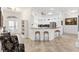 Open-concept kitchen with stainless steel appliances, breakfast bar, and bright lighting at 3141 Roswell Rd, The Villages, FL 32162