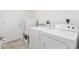 Clean laundry room featuring a washing machine, dryer, and storage space at 3141 Roswell Rd, The Villages, FL 32162