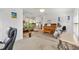 Spacious living room with hardwood floors, a piano, and an open-concept design, creating an inviting atmosphere at 3141 Roswell Rd, The Villages, FL 32162