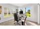 Bright office area features a large window, hardwood floors, and comfortable furniture at 3141 Roswell Rd, The Villages, FL 32162