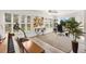 Recreation area featuring hardwood floors, piano, exercise equipment, and large windows at 3141 Roswell Rd, The Villages, FL 32162