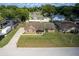 Aerial view of the home with a well-manicured lawn and long driveway at 3295 Se 56 Ave, Ocala, FL 34480