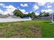 Expansive backyard with green grass and a white privacy fence offers a serene outdoor setting at 3295 Se 56 Ave, Ocala, FL 34480
