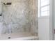 Modern bathroom with a shower featuring marble tiling and a built-in bench at 3295 Se 56 Ave, Ocala, FL 34480