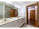 Bright bathroom with double sinks, large mirror, and tiled shower/bath, plus closet in view at 3295 Se 56 Ave, Ocala, FL 34480