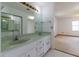 Bathroom vanity featuring double sinks and a large mirror with a view of the bedroom at 3295 Se 56 Ave, Ocala, FL 34480