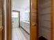 Bright bathroom features double sinks, tile floors, and louvered-door storage with wire shelving at 3295 Se 56 Ave, Ocala, FL 34480