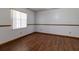 A room with vinyl flooring, trim, and a view of a kitchen through the archway at 3295 Se 56 Ave, Ocala, FL 34480