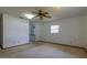 Spacious bedroom with carpet, ceiling fan, and window at 3295 Se 56 Ave, Ocala, FL 34480
