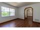 Bedroom with wood-look floors and a window overlooking the backyard at 3295 Se 56 Ave, Ocala, FL 34480