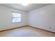 An empty bedroom with carpet flooring, white walls, and a window to the outside at 3295 Se 56 Ave, Ocala, FL 34480