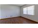 Bright bedroom with wood-look floors, a large window, and freshly painted walls at 3295 Se 56 Ave, Ocala, FL 34480