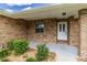 Charming front porch with brick siding, and a well-maintained garden bed at 3295 Se 56 Ave, Ocala, FL 34480