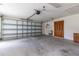 Spacious garage featuring concrete floor, garage door opener, and storage cabinets at 3295 Se 56 Ave, Ocala, FL 34480