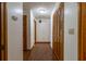 Hallway featuring wood floors, white walls, and wood closet doors at 3295 Se 56 Ave, Ocala, FL 34480