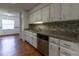 Renovated kitchen boasts granite countertops, stainless steel appliances, and white cabinets at 3295 Se 56 Ave, Ocala, FL 34480