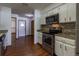 Updated kitchen featuring stainless appliances, granite countertops, white cabinets, and wood-look floors at 3295 Se 56 Ave, Ocala, FL 34480