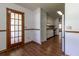 Kitchenette with wood-look flooring, white cabinetry, and granite countertops at 3295 Se 56 Ave, Ocala, FL 34480