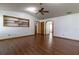 Living room featuring vaulted ceiling, wood look floors and built in shelving at 3295 Se 56 Ave, Ocala, FL 34480