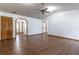 Living room features vaulted ceiling, wood-look flooring, and access to other rooms at 3295 Se 56 Ave, Ocala, FL 34480
