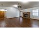 Spacious living room features vaulted ceiling, brick fireplace and wood look flooring at 3295 Se 56 Ave, Ocala, FL 34480