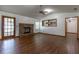 View of the open living room with brick fireplace, ceiling fan and outdoor access at 3295 Se 56 Ave, Ocala, FL 34480