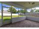 Enclosed screened porch featuring decorative tile, white frame, and overlooking backyard at 3295 Se 56 Ave, Ocala, FL 34480