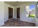 Spacious screened porch boasts decorative tiled flooring, white walls, and two beautiful doors at 3295 Se 56 Ave, Ocala, FL 34480