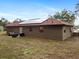 Backyard with a seating area and solar panels on the roof at 346 Emerald Rd, Ocala, FL 34472