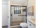 Updated bathroom features an enclosed shower with nice tile, a window, and modern black hardware at 346 Emerald Rd, Ocala, FL 34472