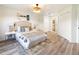 Serene bedroom featuring a large window, neutral decor and wood-look flooring at 346 Emerald Rd, Ocala, FL 34472